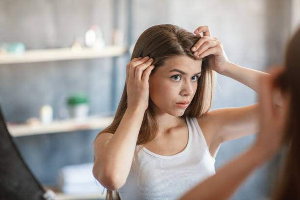 Woman checking her hair and scalp