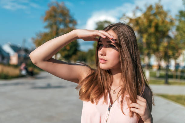 Woman shielding her face from the sun