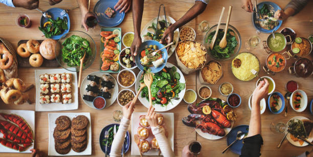 Table presented with different foods and people choosing from the options