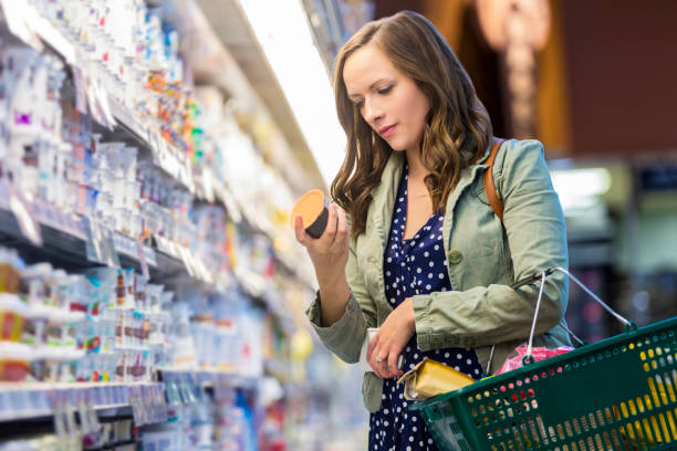 Woman checking nutrition facts on the back of her grocery items