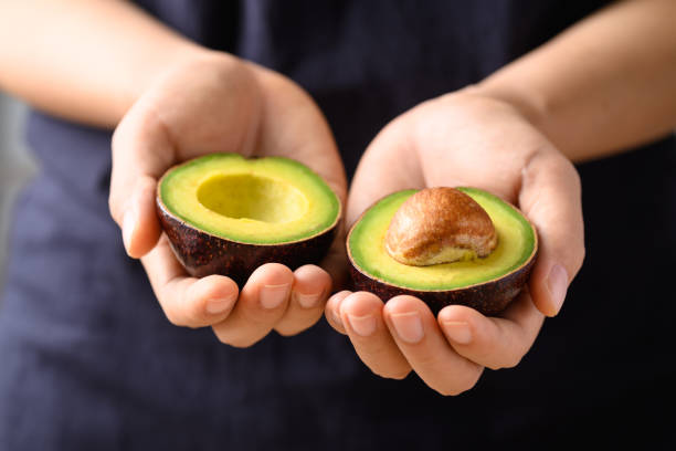 Person holding an open Avocado which is a superfood