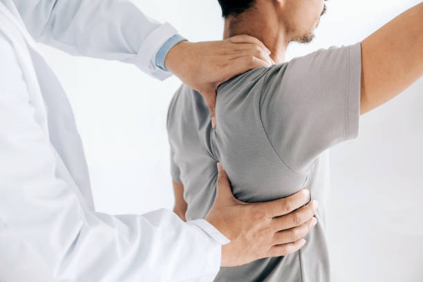 Doctor helping a patient with his joint pain