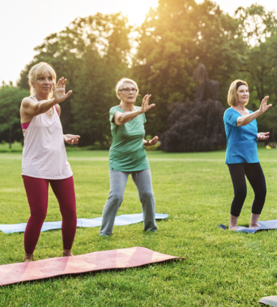 Seniors doing tai chi outdoors